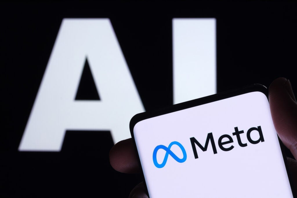 Meta logo seen on smartphone and AI letters on the background. Concept for Meta Facebook Artificial Intelligence. Stafford, UK, May 2, 2023